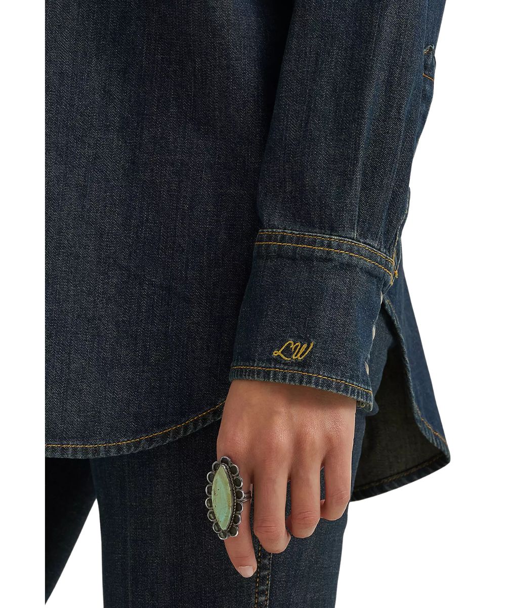 Close-up view of Lainey Wilson's monogram embroidered at the left cuff