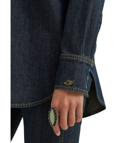 Close-up view of Lainey Wilson's monogram embroidered at the left cuff