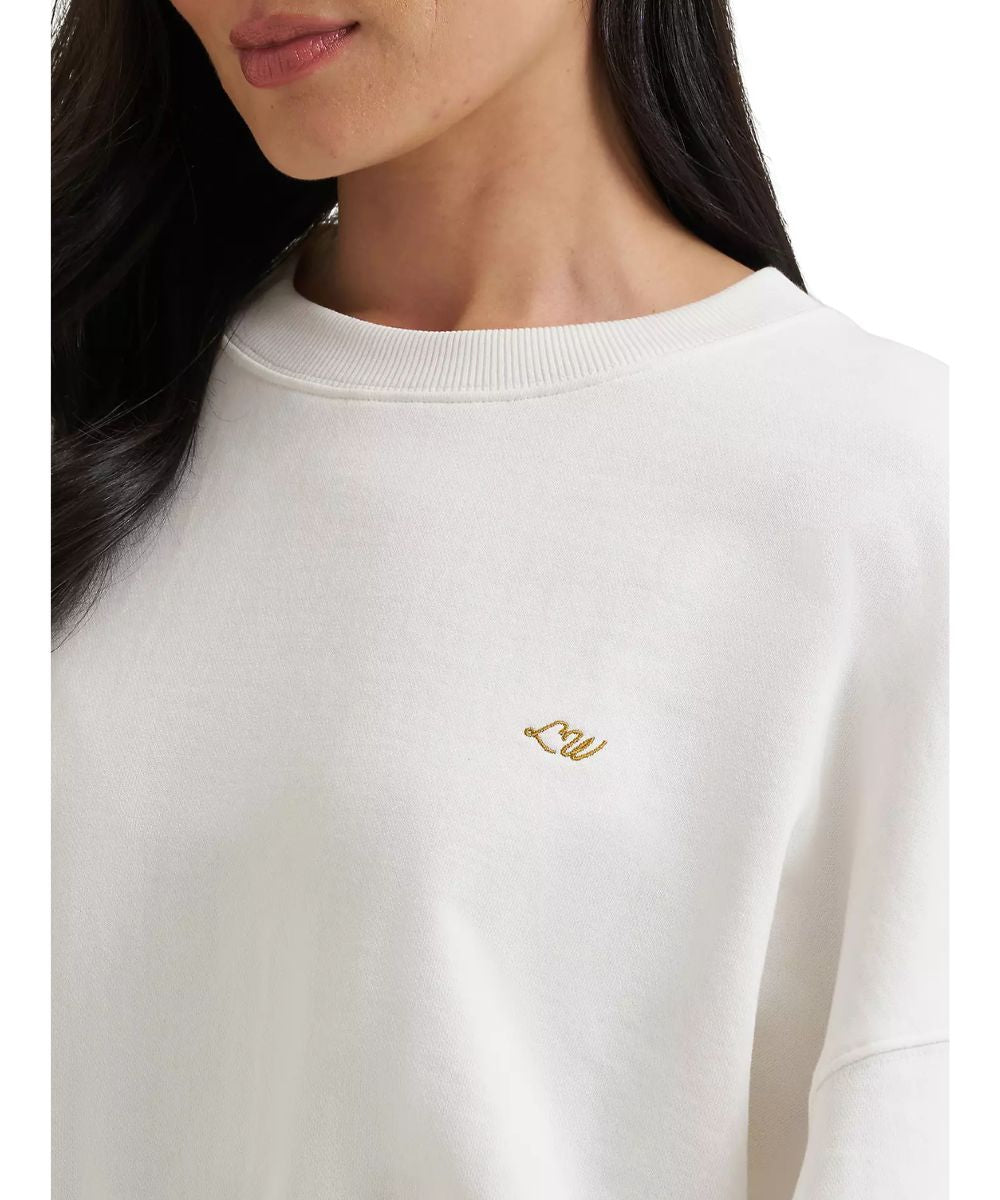 Close-up view of Lainey Wilson's initials embroidered at the left chest