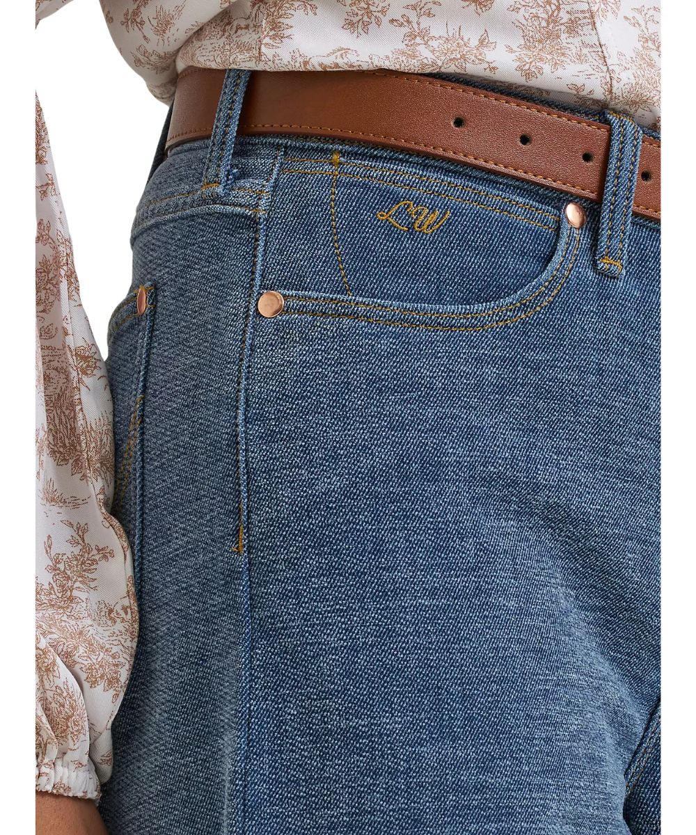 Close-up view of the front pockets featuring Lainey Wilson's initials embroidered on the coin pocket, the high rise, and relaxed fit