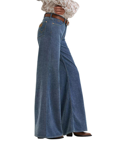 Side view of the women's medium wash wide leg jean featuring the 17.5" leg opening and finished hem
