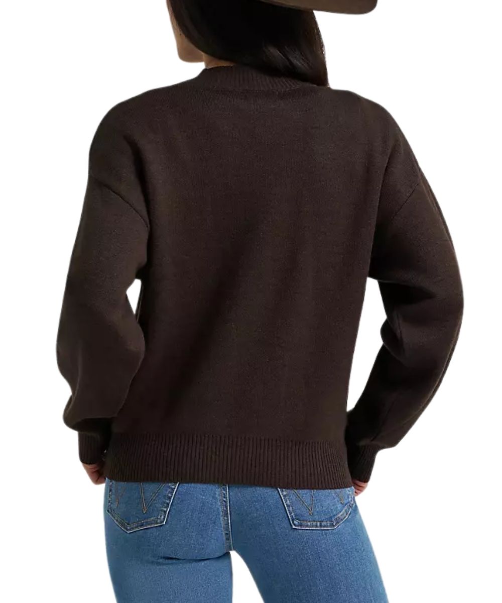 A woman shown from the back wearing a dark brown knit sweater and blue jeans against a plain white background.