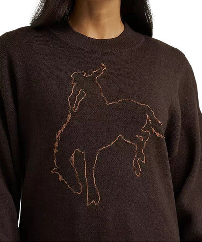 A close-up of a person wearing a dark brown knit sweater with a large embroidered outline of a horse and rider in a warm tan or copper thread on the chest.