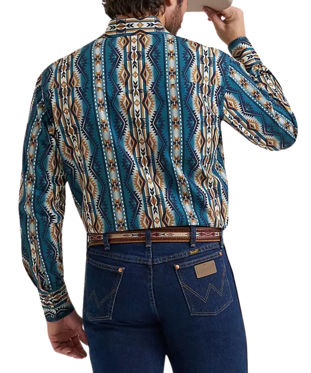 A man viewed from the back wearing a long-sleeve western-style button-up shirt with a bold Southwestern geometric pattern in teal, brown, beige, and white, paired with dark blue jeans and a patterned belt.