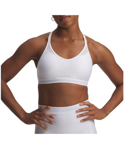 Front view of the women's white Under Armour low sports bra featuring the adjustable spaghetti straps, deep v-neckline, removable padded cups, mesh panels for breathability, and an elastic band with halo gray logo woodmark