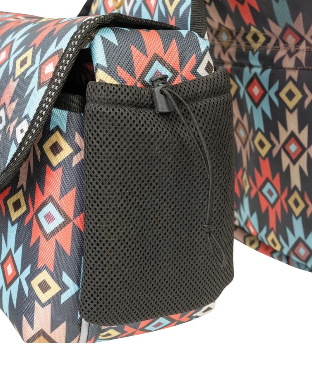 Close-up of a patterned bag with a black mesh side pocket and drawstring, showing a geometric Southwestern-style print in black, red, blue, beige, and yellow.