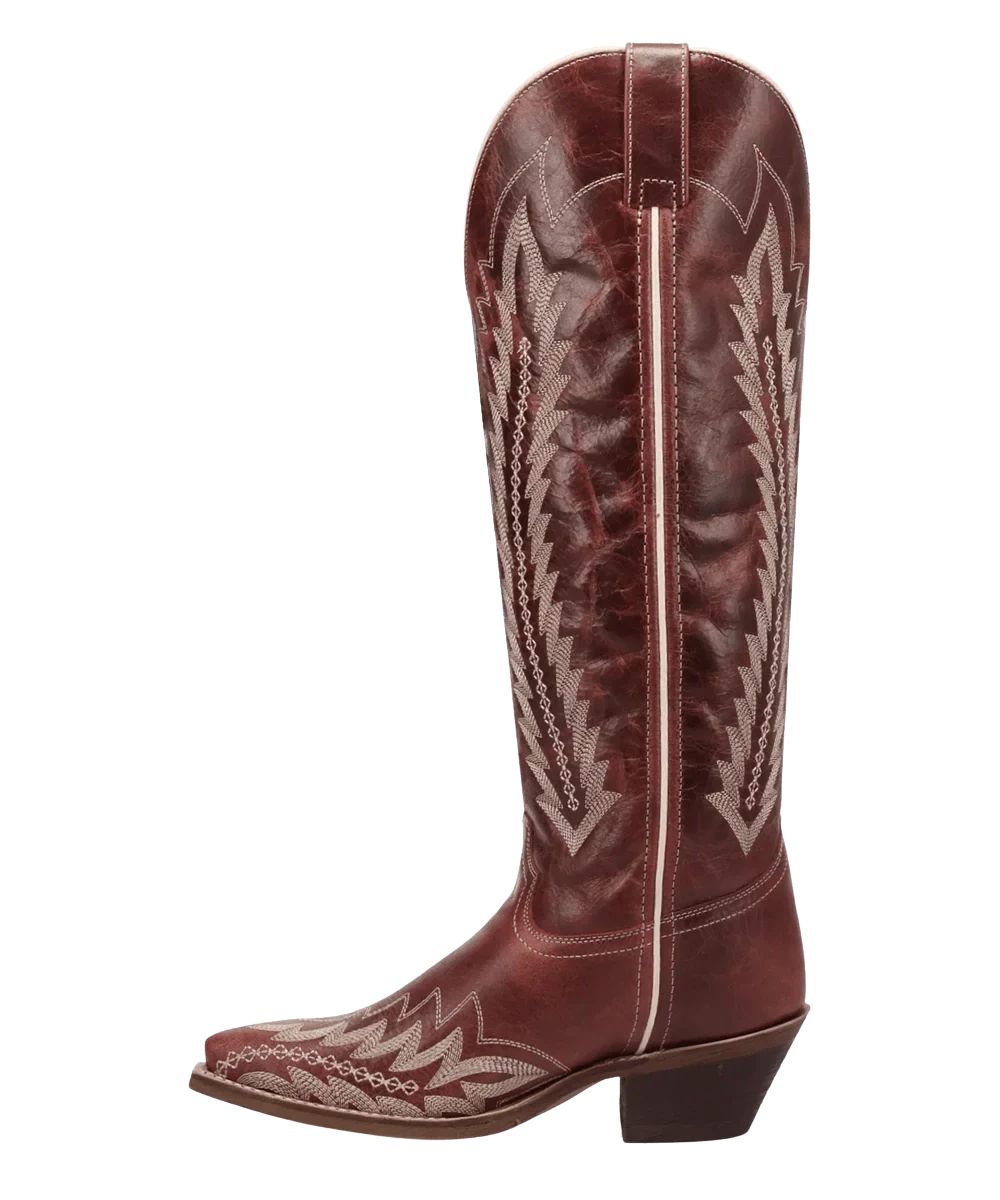 Left side view of the women's red leather fashion boot featuring the pull tabs for an easy on