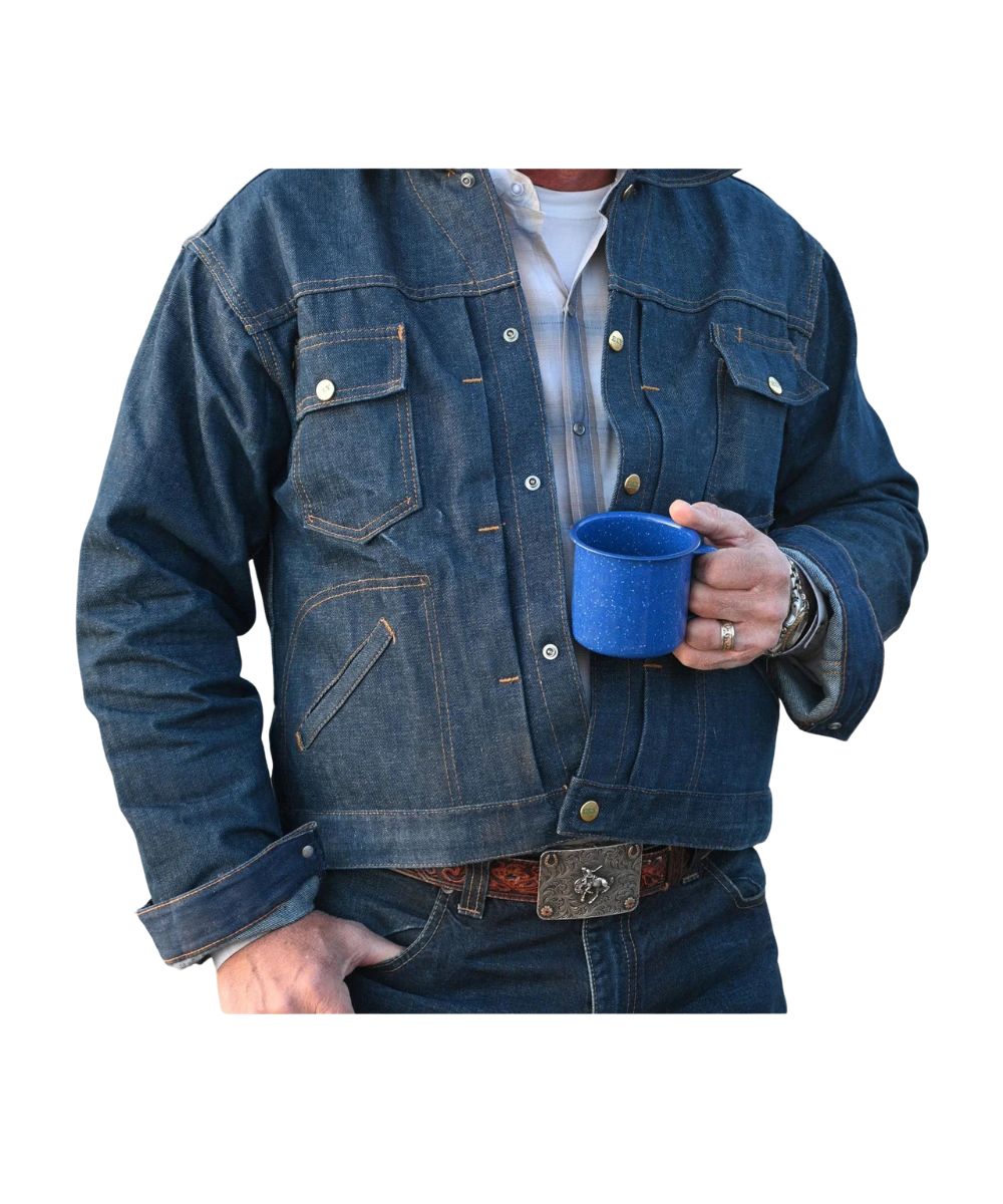 Model view of the men's denim blue Ely Cattleman trucker jacket featuring the snap closure, spread collar, snap flap chest pockets, hand pockets, and snap cuffs