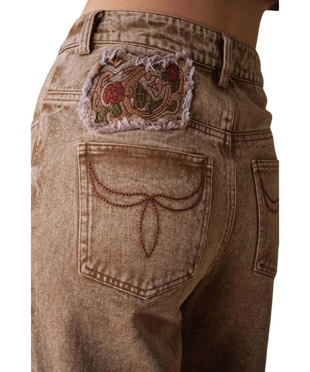 Close-up view of the western floral embroidery above the back pocket
