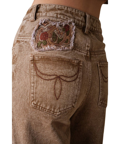 Close-up view of the western floral embroidery above the back pocket