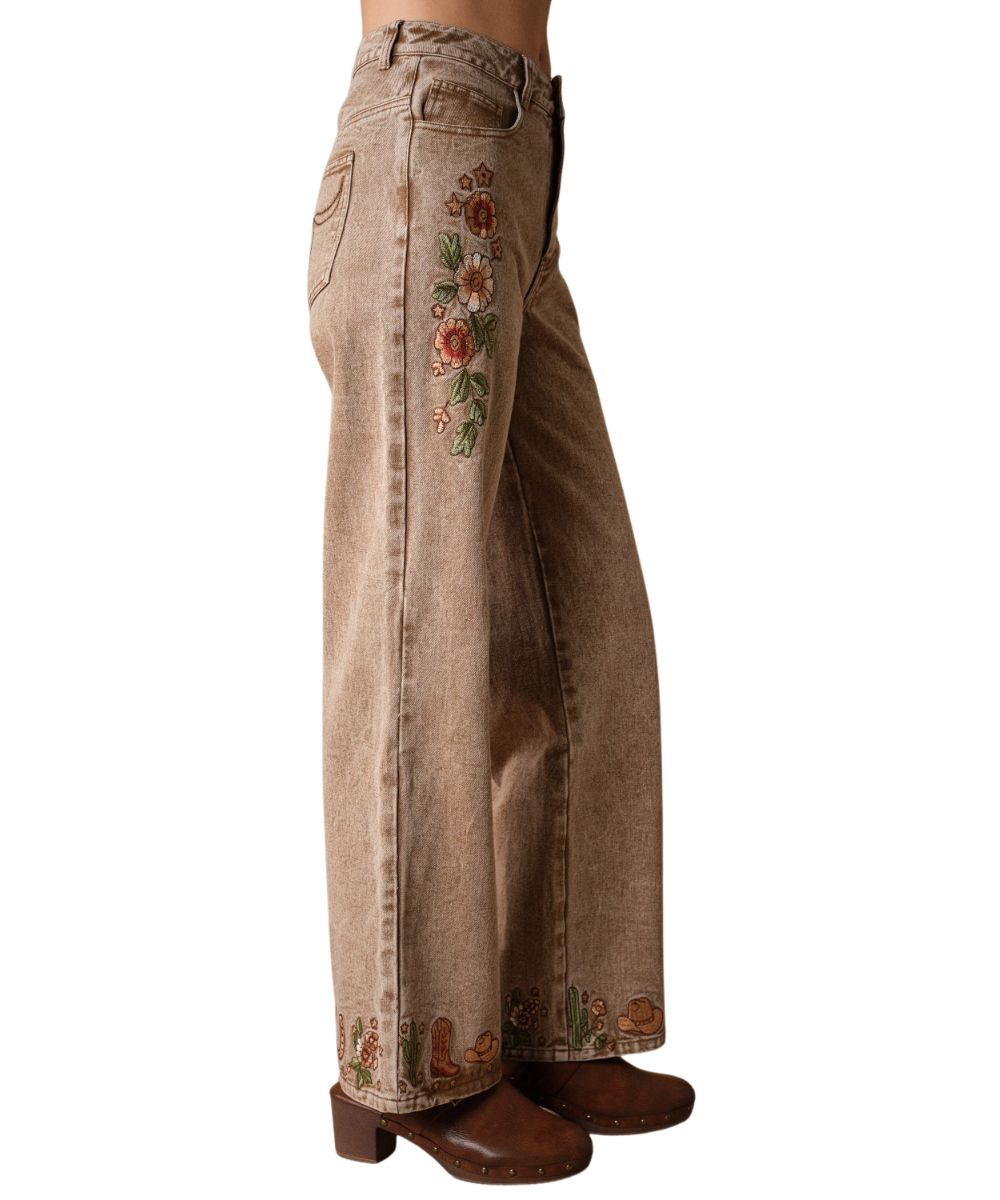 Side view of the women's mocha wide leg jean featuring the western embroidered hems and floral embroidery along the thigh