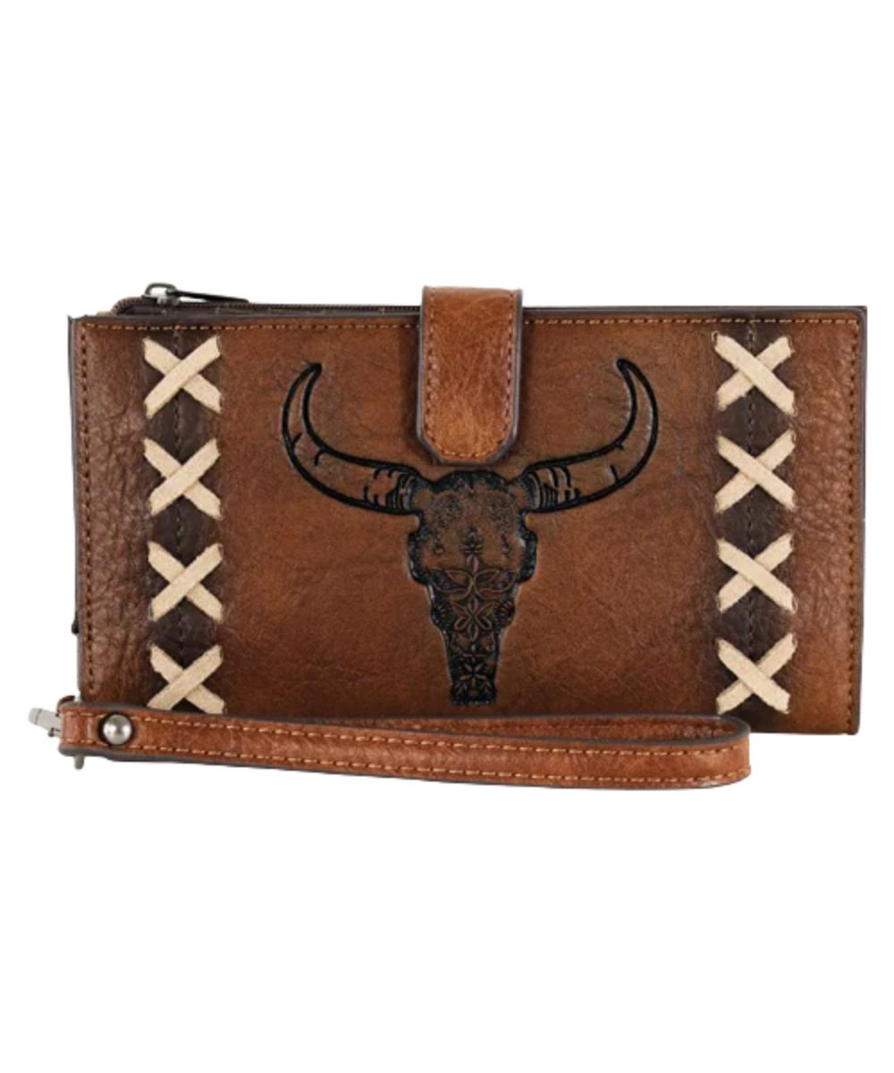 Front view of the women's tan Catchfly wristlet wallet featuring the steer skull and x stitching on the front, snap strap closure, and a removable wristlet strap