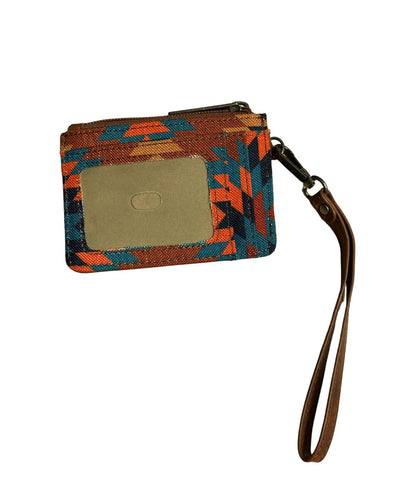 A small zippered card holder or wristlet pouch with a geometric pattern in orange, blue, and brown, featuring a tan plastic ID window and a brown wrist strap.