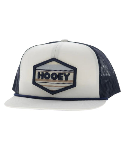 Left angled view of the unisex adult's Hooey Mesa Trucker Snapback Cap featuring the white front with cream and navy hexagon logo embroidery, white hybrid bill with a navy brim rope, and navy mesh sides