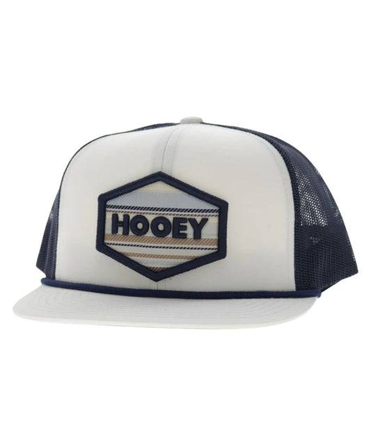 Left angled view of the unisex adult's Hooey Mesa Trucker Snapback Cap featuring the white front with cream and navy hexagon logo embroidery, white hybrid bill with a navy brim rope, and navy mesh sides