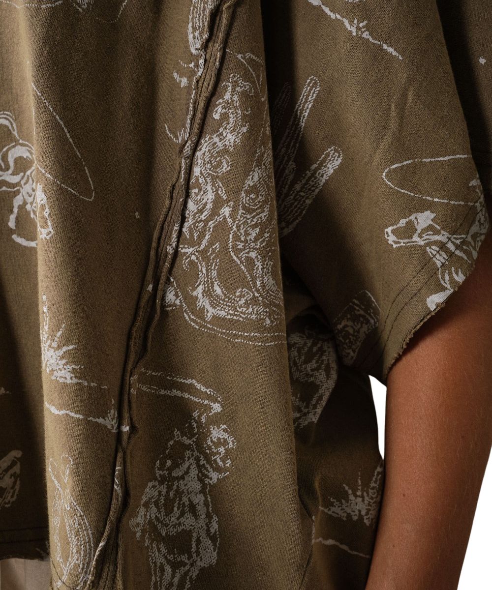 Close-up of the women's tee in olive with a white line-art graphic print and the exposed seams