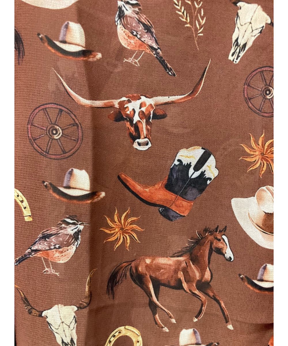 Close-up view of the russet brown blouse with a western print
