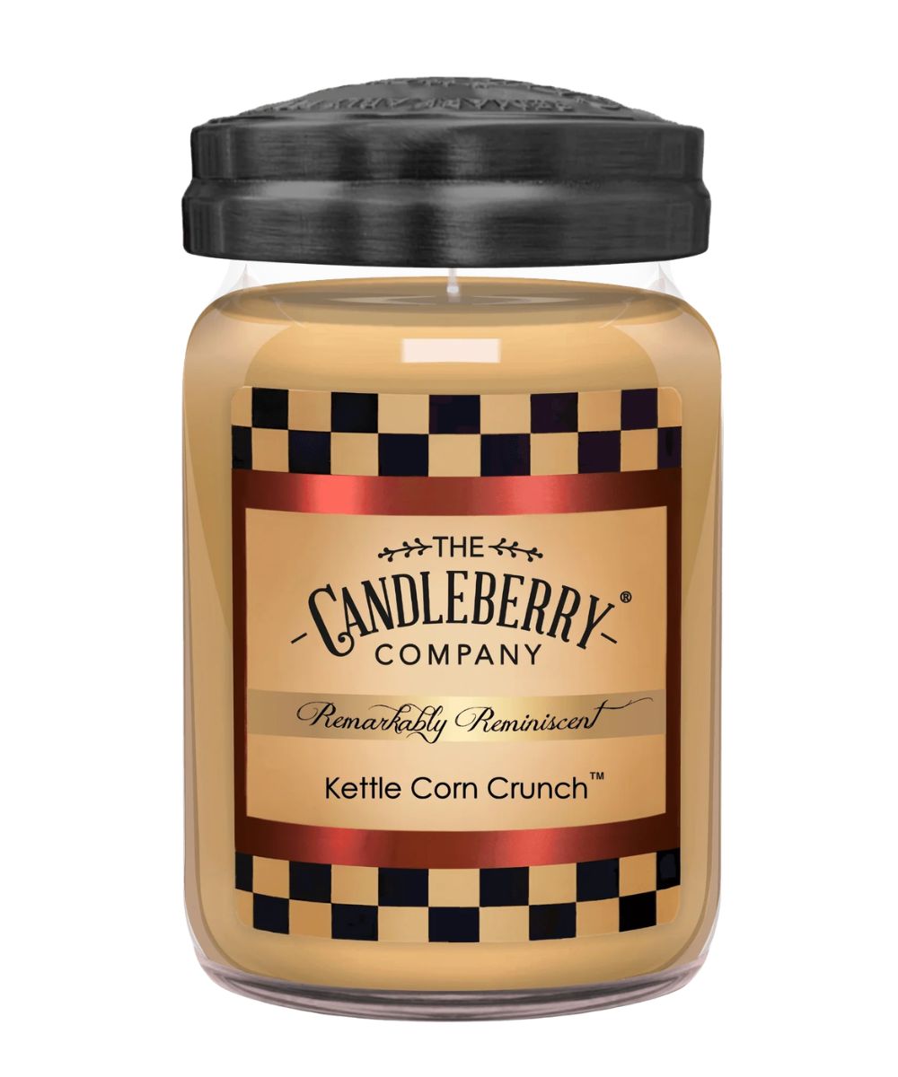A jar candle from The Candleberry Company in the scent Kettle Corn Crunch, featuring a black lid, clear glass jar, and a label with a tan background, black-and-white checkered borders, and red metallic accents.