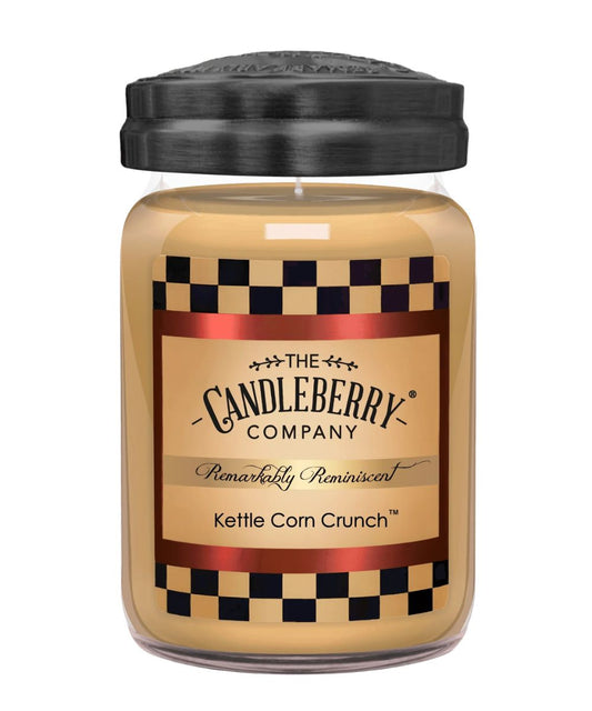 A jar candle from The Candleberry Company in the scent Kettle Corn Crunch, featuring a black lid, clear glass jar, and a label with a tan background, black-and-white checkered borders, and red metallic accents.