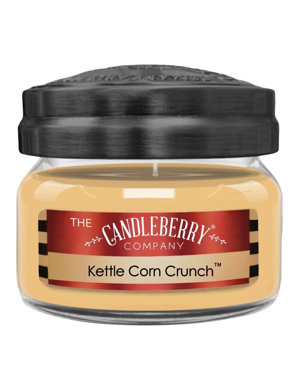 A jar candle with pale yellow wax in a clear glass container, a black lid, and a red and beige label reading 'The Candleberry Company' and 'Kettle Corn Crunch'.