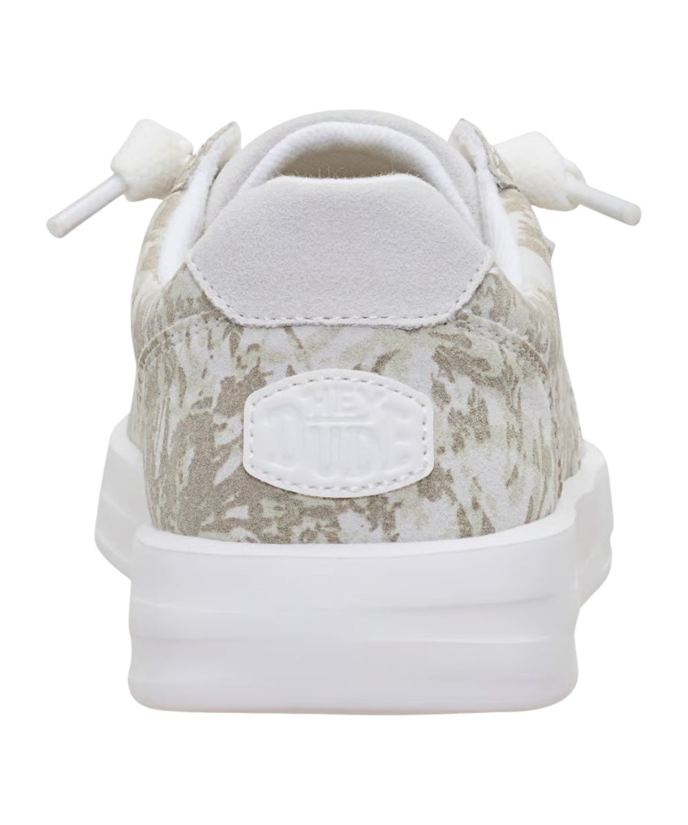Heel view of the women's white camo sneaker shoe featuring the logo patch at the heel