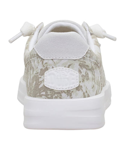Heel view of the women's white camo sneaker shoe featuring the logo patch at the heel