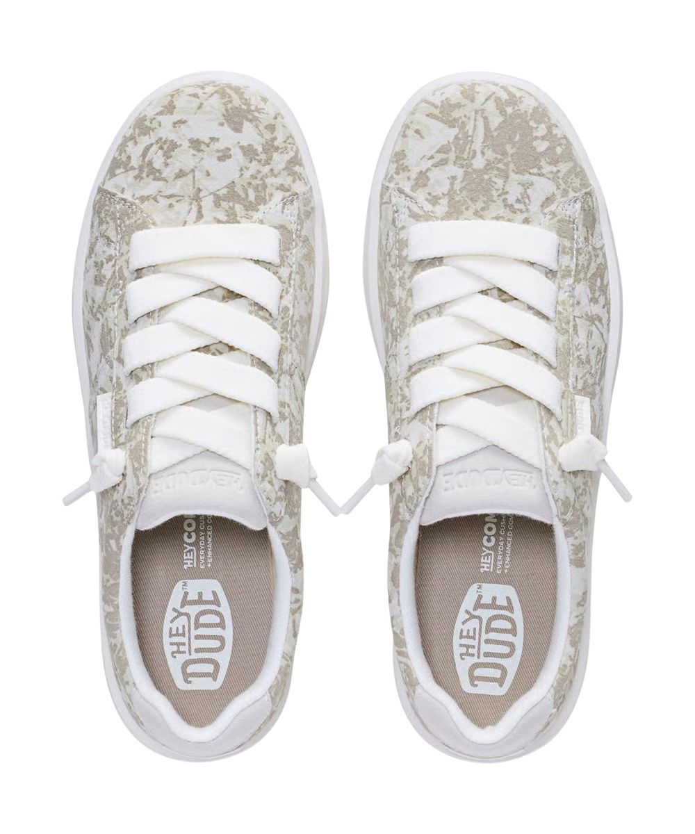Aerial view of the women's white slip-on sneaker featuring the round toe and knotted elastic laces
