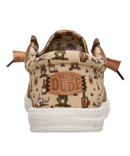 Heel view featuring the beige wild western print with cacti and whiskey graphics and a logo label