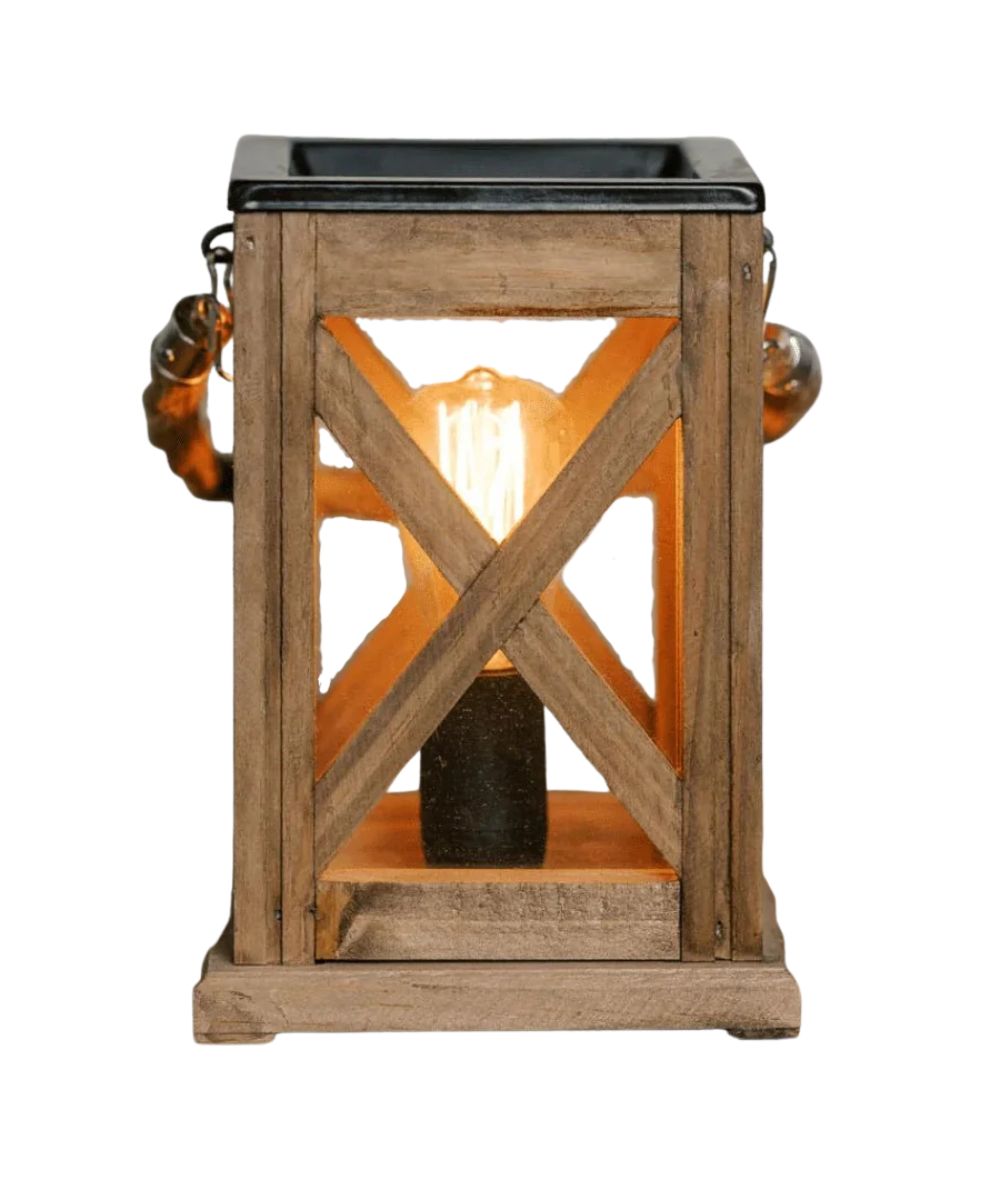 A rustic wooden lantern with a warm glowing Edison bulb inside, featuring a black top panel and decorative metal side handles, shown against a plain white background.