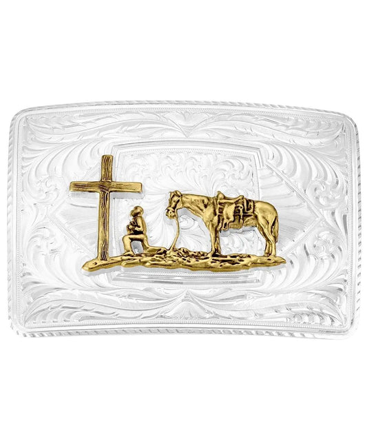 Front view of the men's silver belt buckle featuring the gold cowboy kneeling at the cross with his horse