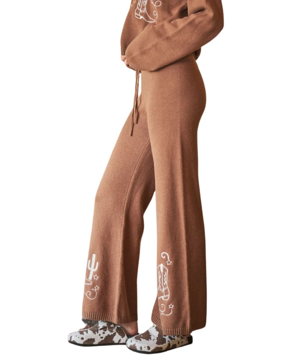 Side view of the women's mocha brown sweatpants featuring the wide leg, boot and cactus embroidery accents at the hem, and ribbed trim
