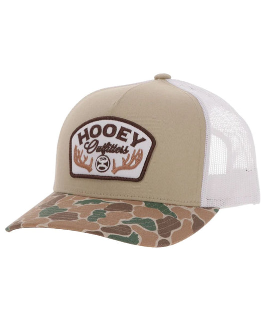 Left angled view of the unisex adult's Hooey Outfitters Ball Cap featuring the tan front with a brown and white embroidered logo patch that reads: "Hooey Outfitters" with an antler graphic, a duck camo curved bill, and white mesh sides