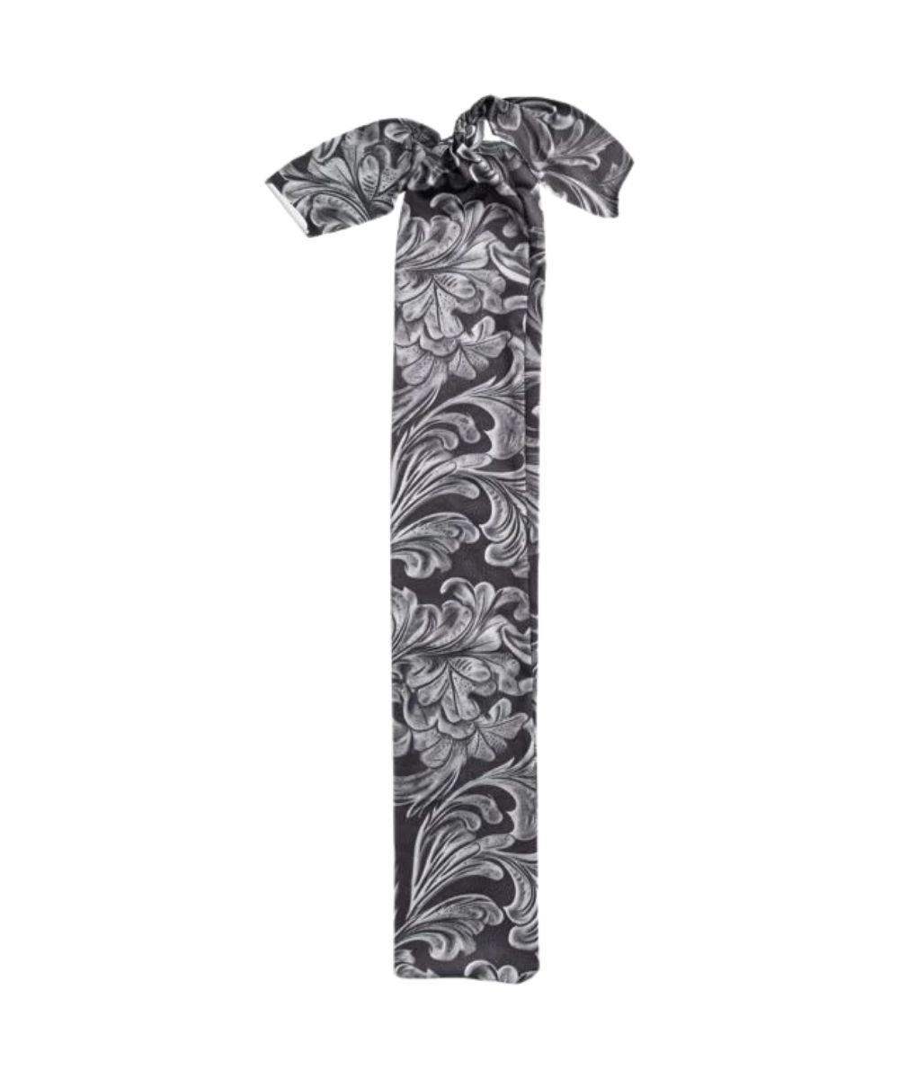 A printed tail bag with a black tooled design