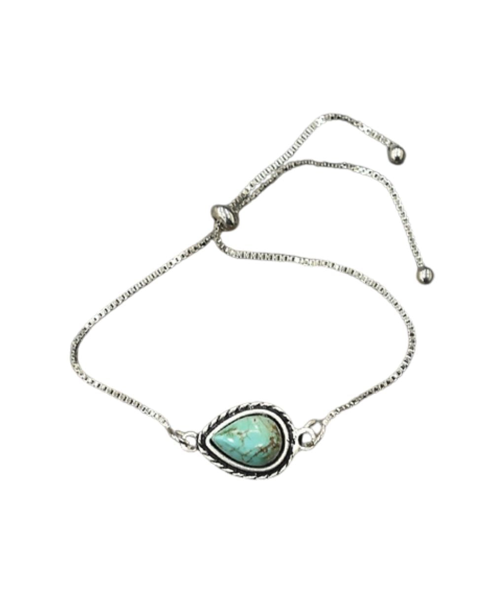 Flat view of the women's silver snake chain adjustable bracelet featuring the turquoise teardrop shaped stone by Isac Trading Inc.