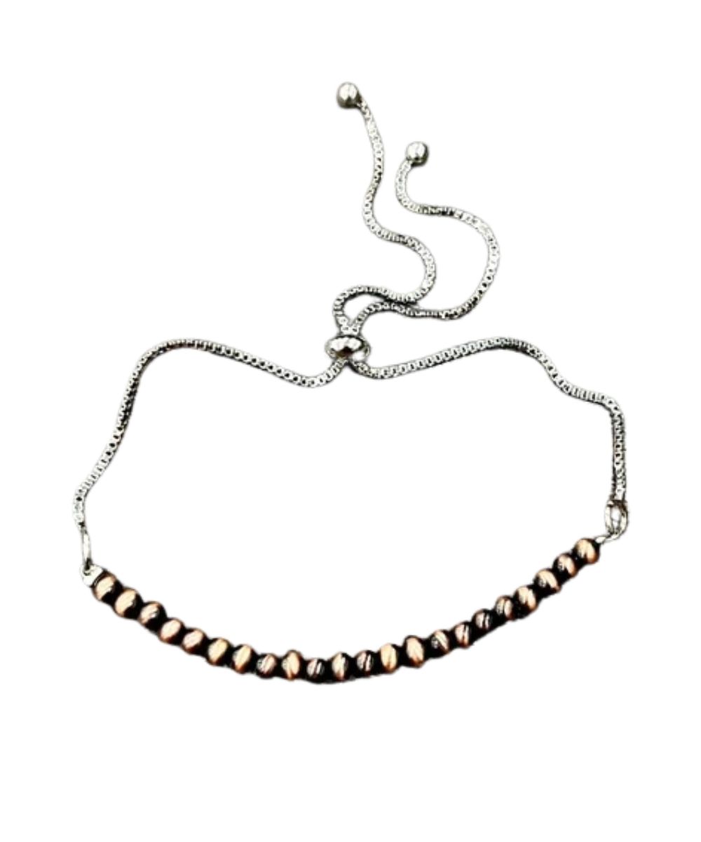 Flat view of the women's adjustable bracelet featuring the copper beads