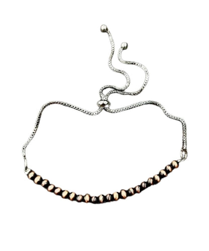 Flat view of the women's adjustable bracelet featuring the copper beads