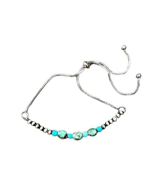 Flat view of the women's Isac Trading Adjustable Chain Bracelet featuring the oval gemstones and navajo beads