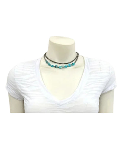 Model view of the women's western Isac Trading beaded necklace featuring the 2 strands, one with tiny 4mm silver faux navajo beads, and the other with faux navajo beads and oval turquoise gemstones
