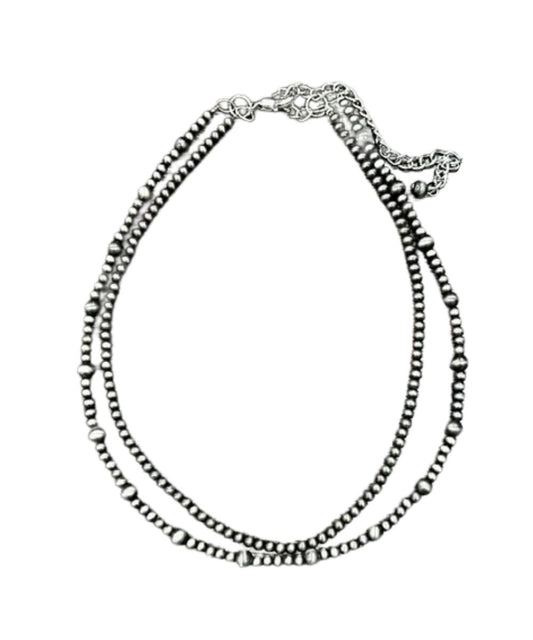 Flat view of the women's silver 16" long necklace with a 5" extender