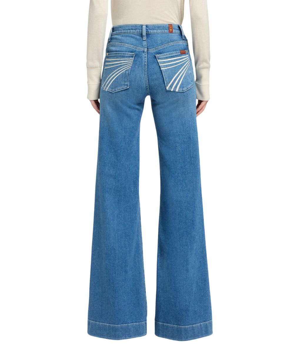 Back view of the women's high rise trouser jean featuring the mid wash and trouser hem