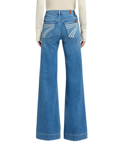 Back view of the women's high rise trouser jean featuring the mid wash and trouser hem