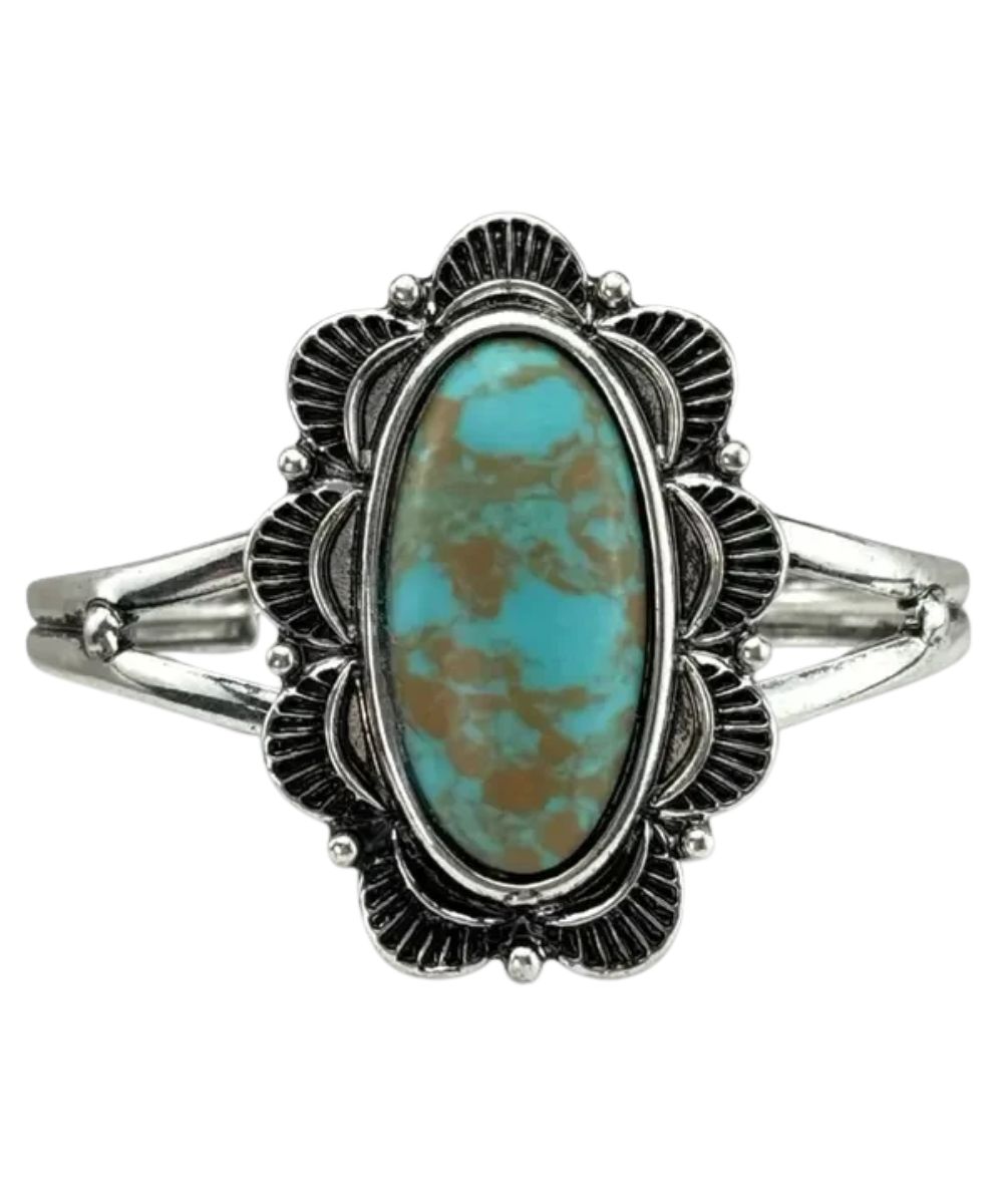 Pink Panached women's silver tone cuff bracelet featuring the large oval turquoise stone in the center surrounded by a scalloped edge