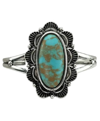 Pink Panached women's silver tone cuff bracelet featuring the large oval turquoise stone in the center surrounded by a scalloped edge