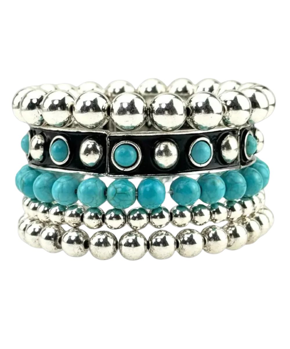 A stack of five beaded stretch bracelets on a plain white background. The stack includes silver ball beads, turquoise and silver spacer beads, a black band with turquoise stones, turquoise round beads, and silver and turquoise marbled beads.