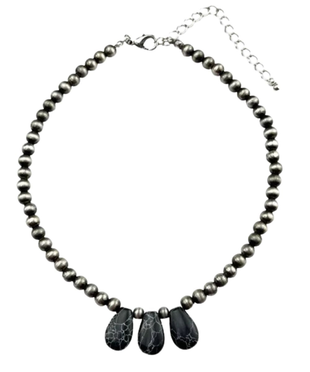 Flat view of the women's black Pink Panache 15" necklace with extender chain and 3 black teardrop shaped pendant stones