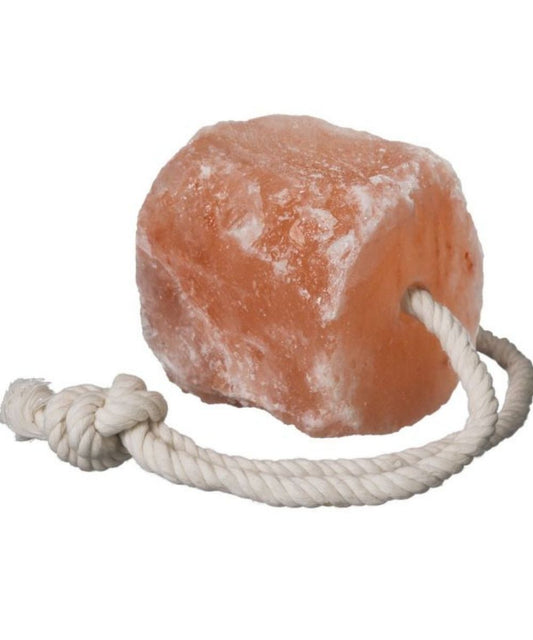 View of pinkish white Tough1 rock salt with white rope  coming out the top.