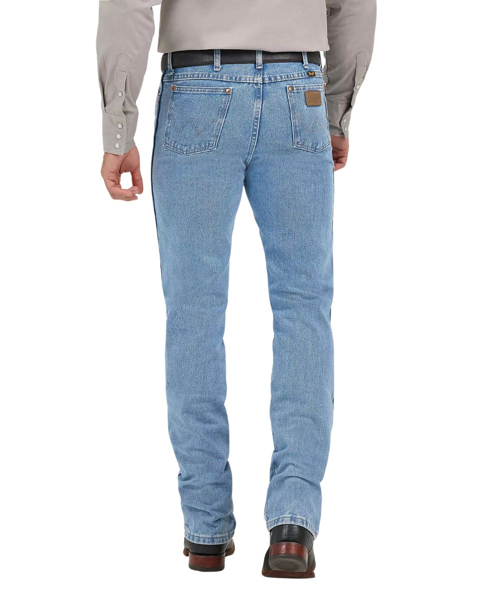 Back view of the men's antique washed cowboy cut jeans featuring the tapered leg, 'w' logo stitched back pockets with a neolite logo patch, and the high rise