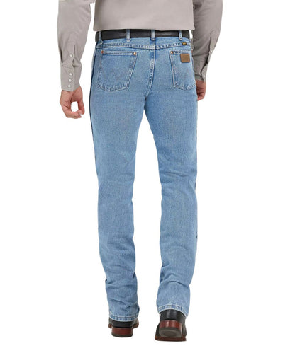 Back view of the men's antique washed cowboy cut jeans featuring the tapered leg, 'w' logo stitched back pockets with a neolite logo patch, and the high rise