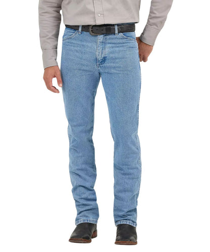 Front view of the men's antique/medium wash Wrangler Cowboy Cut Jeans featuring the slim fit, high rise, five pocket styling, and tapered leg