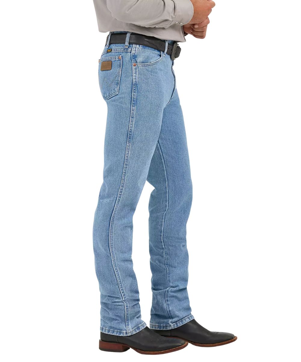 Side view of the men's slim fit cowboy cut jean featuring the antique wash and tapered leg
